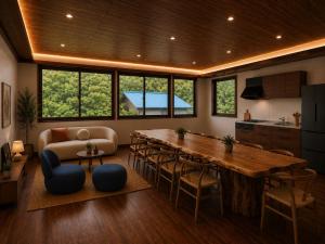 a kitchen and living room with a large wooden table at LUX Niseko lodge in Niseko +13 photos