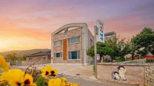 a building with a sign in front of it at Samcheok Eoulim Pension in Samcheok +2 photos