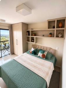 a bedroom with a large bed with green sheets at Flat Monte Castelo ,Vista Incrível,Conforto in Sairé +64 photos