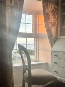 a chair sitting in front of a window at Donegal Cottage in Inver +4 photos