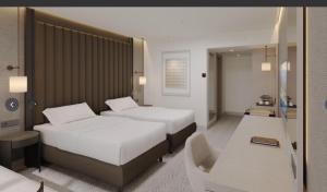 a hotel room with two beds and a chair at Harun Fars in Yalova