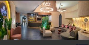 a living room with couches and chairs and a kitchen at Harun Fars in Yalova