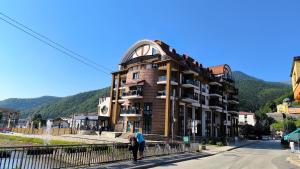 a building with people standing in front of it at Srce Fojnice in Fojnica