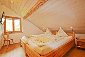 a bedroom with a large bed in a attic at Wagnerhof in Au am Inn