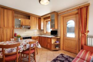 a kitchen with a table and a dining room at Baita sulle Alpi Livigno in Livigno