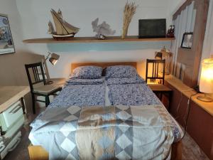 a bedroom with a bed and two chairs at Mühle am Sandbach in Niedererbach