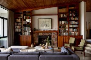 a living room with two couches and a fireplace at Leshiba Wilderness in Louis Trichardt