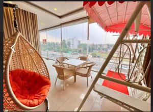 a room with a hammock and a table and chairs at Hotel PG Grand in Mohali