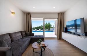 a living room with a couch and a tv at Villa Tea Polača Biograd na moru Benkovac in Polača