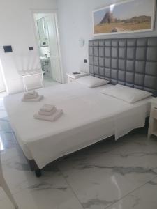 a large white bed in a white room at Masseria SoleMare Gallipoli in Pizzo