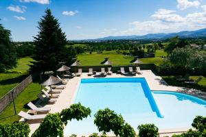 a view of a pool with lounge chairs and a resort at Domaine De Saint Clair in Saint-Clair