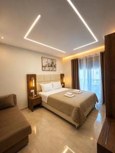 a bedroom with a large bed and a couch at Arbneshi Apartments in Ulcinj