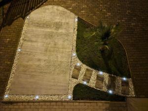 a sign on a brick wall with lights at Studio 28 in Kobiljak Sesvetski
