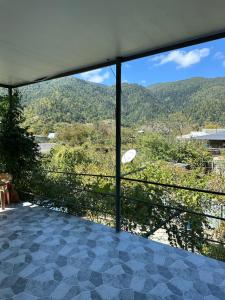 a room with a view of a mountain at Guest House Mukha in Akhaldaba