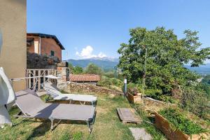 a patio with two chairs and a view of mountains at Da Dani Casa Vacanza in Pontremoli
