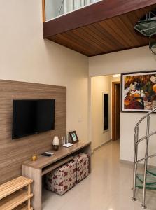 a living room with a flat screen tv on a wall at Flat Monte Castelo ,Vista Incrível,Conforto in Sairé