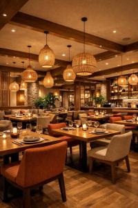 a restaurant with tables and chairs and chandeliers at The- Luxury Enclave Plaza Near IGI Airport Delhi in New Delhi