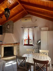 a living room with a table and a fireplace at House Zrno Peaceful Stone House in Račišće, Korčula in Račišće