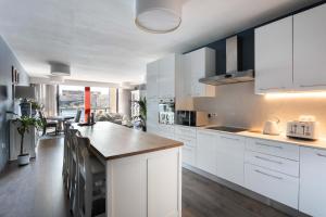 a kitchen with white cabinets and a counter top at St Angelo Mansions 3BDR flat with Seaview in Vittoriosa +8 photos