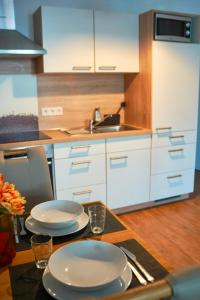 a kitchen with a table with plates on it at PrimeBnb Am Marktplatz in Bad Hersfeld