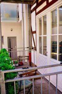 a porch with a table and chairs on a balcony at PrimeBnb Am Marktplatz in Bad Hersfeld