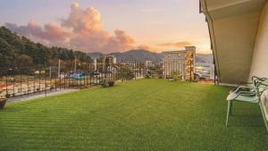 a balcony with a large yard with a view at Chuncheon Lio Pension in Chuncheon