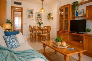 a living room with a couch and a table at Miquel 1 – Piso con Parking y Wifi en el Centro in Tossa de Mar
