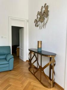 a living room with a table and a blue couch at Vila Popovici in Prăjila