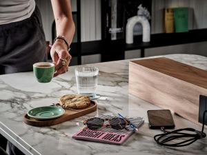 a person is holding a cup of coffee on a table at TRIBE Paris Pantin in Pantin