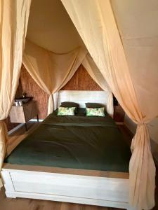 a bedroom with a bed in a tent at L'EVIDENCE Love Room & spa in Chaveignes