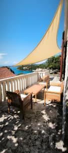 a group of benches sitting on top of a patio at House Zrno Peaceful Stone House in Račišće, Korčula in Račišće
