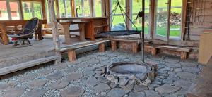 a porch with a fire pit and a swing at U Janusza in Zadwórze