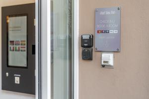 a door with a sign on the side of a building at Hotel Neue Post I self check-in in Innsbruck