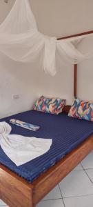 a bed in a room with a canopy at Shalom Homestay in Kilindoni