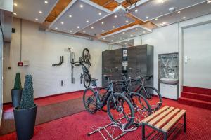 two bikes parked in a room with a bench at Hotel Neue Post I self check-in in Innsbruck +110 photos