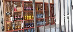 a shelf filled with lots of bottles of alcohol at Shalom Homestay in Kilindoni