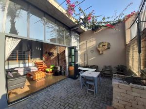 a patio with a large glass door and a table at The Regiment Self Catering Accommodation has 3 x 4 sleeper units in Cape Town