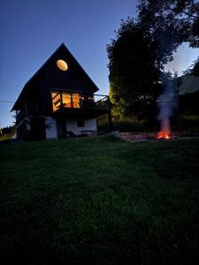 a fire burns in front of a house at Chata Slovena in Novoť