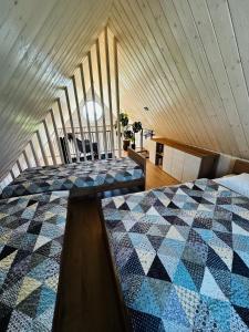 a bedroom with two beds in a room at Chata Slovena in Novoť +6 photos