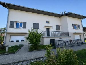 a white house with black shutters at Chambre single à louer dans une colocation in Thyez