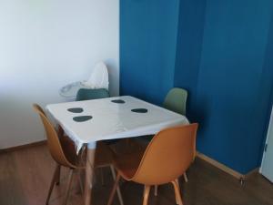 a table in a room with chairs around it at Gosen appart in Athis-Mons