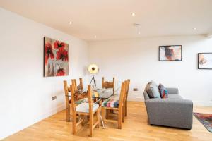 a living room with a table and chairs and a couch at Whinny Brae in Broughty Ferry