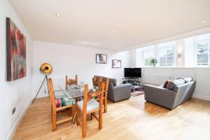 a living room with a glass table and chairs at Whinny Brae in Broughty Ferry