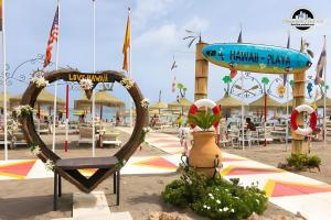 a resort with a beach with tables and chairs at El Bajondillo Apartment in Torremolinos