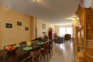 a kitchen and dining room with a table and chairs at Les chaillées in Saint-Romain-en-Jarez