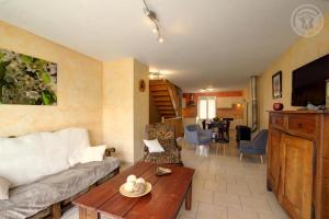 a living room with a couch and a table at Les chaillées in Saint-Romain-en-Jarez