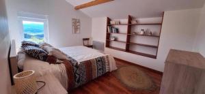 a bedroom with a large bed and a window at Les chaillées in Saint-Romain-en-Jarez