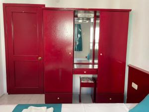 a red cabinet with a sink and a mirror at Villa Nergis in Bitez +25 photos