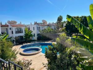 a backyard with a swimming pool and some buildings at Villa Nergis in Bitez