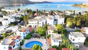 an aerial view of a town with white buildings and the water at Villa Nergis in Bitez